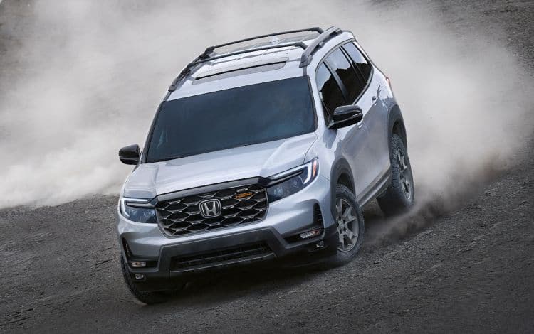 2025 Honda Passport Trailsport 7/8 Front driver side in Lunar Silver Metallic driving on a dirt hill